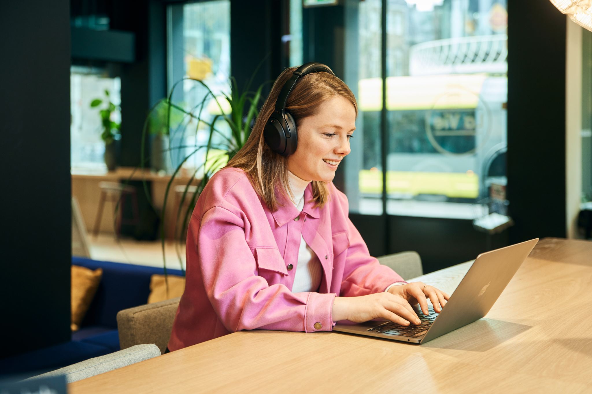 vrouw-laptop-typend-koptelefoon